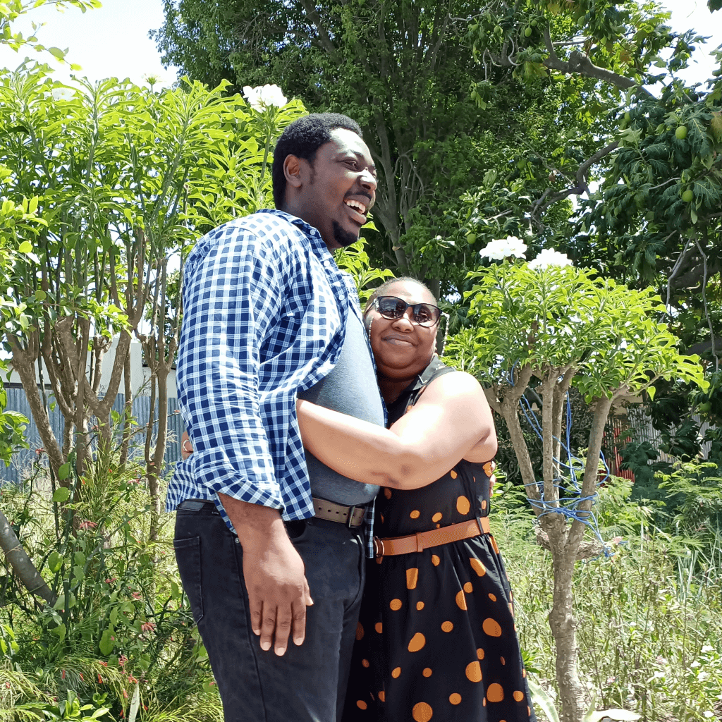 Couple posing together (garden setting).