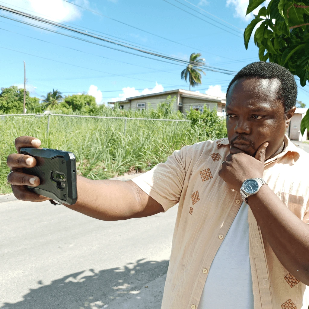 A man taking a selfie with his phone.